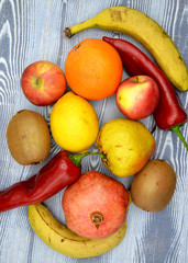 fresh fruits and vegetables on wooden background