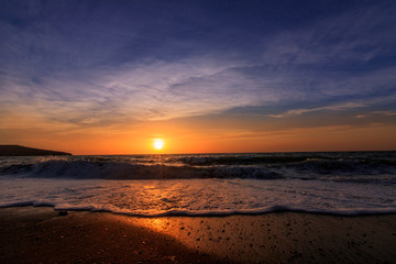 Sunset or sunrise at the sea.  beautifully photographed with sunlight and waves on the beach