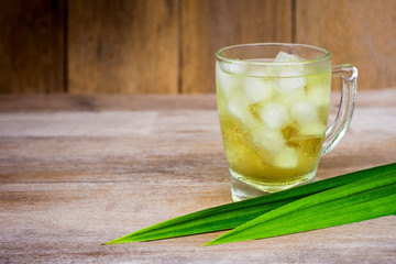 Glass of fresh panda tea isolated on table background.