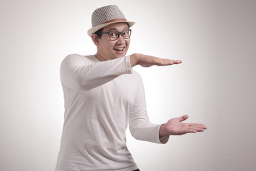 Happy Young Man Showing Something Between His Hands
