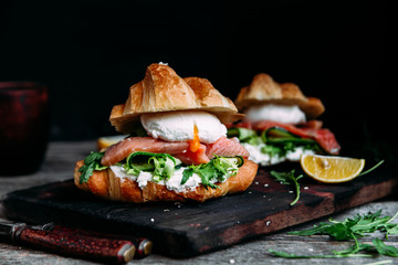 Croissant with salmon, cream cheese, poached egg and lettuce