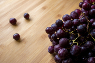 Grape on top of a wooden board