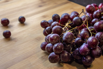 Grape on top of a wooden board