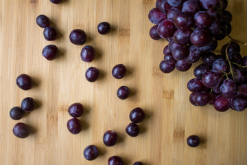Grape on top of a wooden board