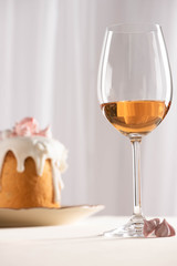 selective focus of Easter cake near wine glass and meringue
