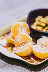 Quartiers de mandarine et bol de grains de maïs