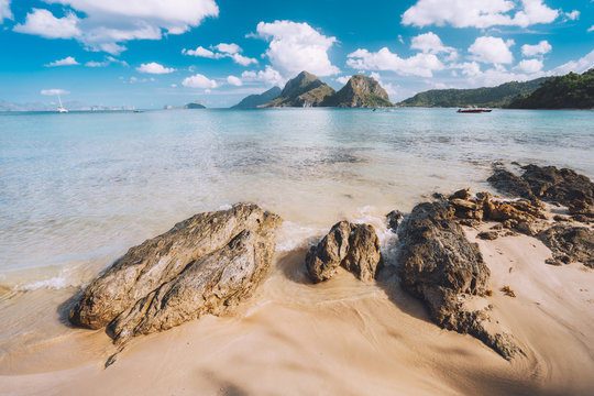 Sandy Beach with rocks and mountains in Background, El Nido, Palawan, Philippines
