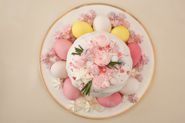 top view of tasty fresh Easter cake with painted eggs and meringue on plate