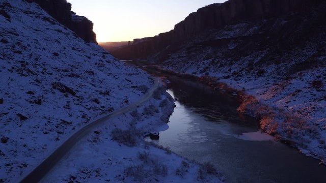 Aerial Footage Flyover Following Car Alongside  Colorado River in Wintertime Near Moab, Utah U.S.A.  by Drone