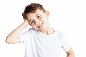 Closeup portrait of sad child with headache holding his head with hand isolated on white background. Worldwide epidemic of coronavirus covid-2019. Health and medical care. Quarantine. Insurance.