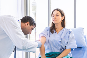 Fototapeta premium Asian doctor Injection vaccines to pretty patient woman with syringe for protect her from sickness or disease