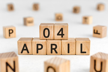 April 4 - from wooden blocks with letters, important date concept, white background random letters around