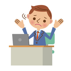 デスクでノートパソコンを使うビジネスマン（困った表情）