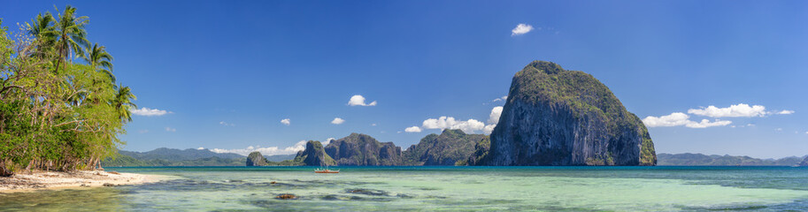 Impressive Pinagbuyutan Island, ocean bay and background mountains. El Nido Panorama of Palawan, Philippines. Turquoise shallow lagoon at sunny day © Igor Tichonow