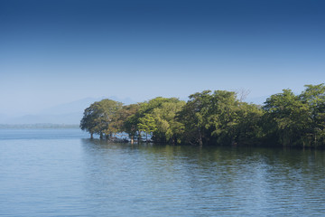 Fototapeta na wymiar Udawalawe, Sri Lanka dramatic view across a lake.