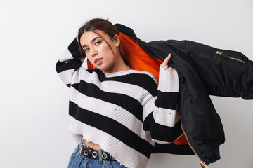 Image of young brunette woman posing with black jacket