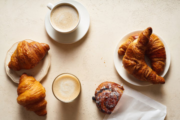 Flatlay with coffee and croissants. Breakfast beverage with pastry. Morning set