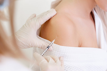 Young unidentified woman immunologist doctor vaccines a young caucasian girl. Vaccine ambiguous concept. Vaccination consequences and saved lives from vaccinations