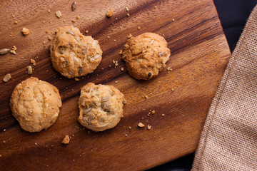 Cookies is on wooden plate. Top view