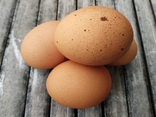 chicken eggs on a bamboo board
