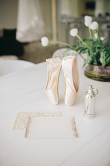 wedding invitation and perfume on a table
