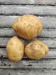 fresh petatoes lying on bamboo board