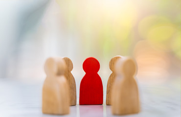 Figure in human resource management concept. The group of wooden puppets is a circular. A red...
