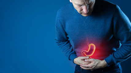 Man touching stomach painful suffering from stomachache causes, gastric ulcer or gastrointestinal...