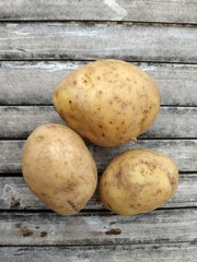 ripe petatoes lying on bamboo board