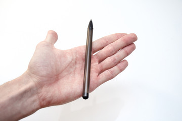 Young male hand holds a black pen on a white background