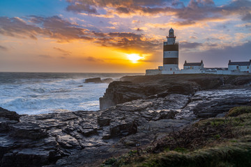 Hook Lighthouse at sunset, the worlds oldest lighthouse is located in the south east of Ireland in...