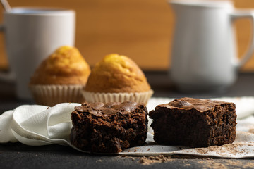 Chocolate brownie and muffins with cup of coffee