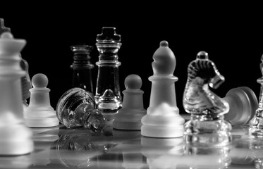 Perspective view on chess play with pieces defeated. Victory, team play, and business strategy concept background.