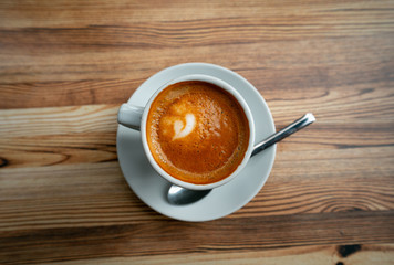 white coffee cup on wooden table