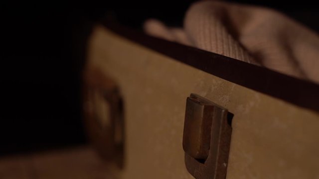 detail of vintage suitcase lock that opens