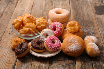 assorted of pastry, donut, puff pastry on wood background
