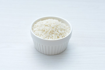 Natural raw white rice grains, on display in bowl