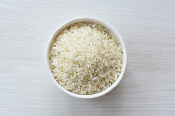 Natural raw white rice grains, on display in bowl