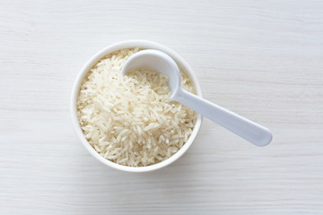 Natural raw white rice grains, on display in bowl