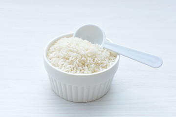 Natural raw white rice grains, on display in bowl