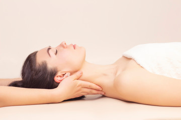 Fototapeta na wymiar neck massage in a spa salon for a girl. concept of health massage. light background.