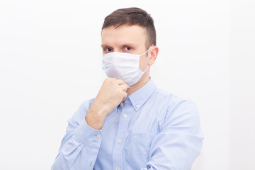 Portrait of a man on a white isolated background, face covered with a medical mask, banner for text. Health, awareness, and timeliness. Healthy lifestyle. No viruses.
