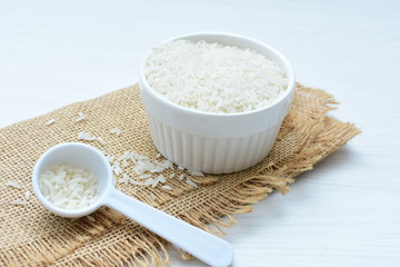 Natural raw white rice grains, on display in bowl
