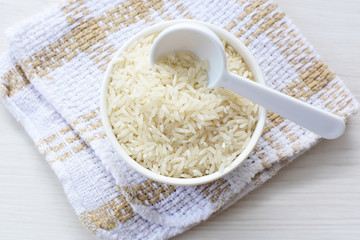 Natural raw white rice grains, on display in bowl