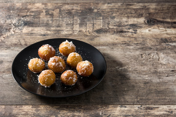 Carnival fritters or buñuelos de viento for holy week on wooden table. Copy space	