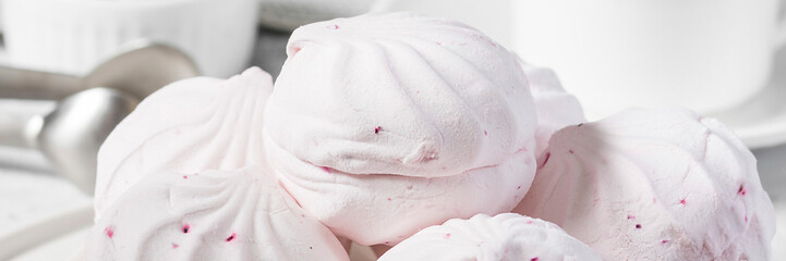 Pink marshmallow with black currant on a plate. Light grey background. Banner for the site