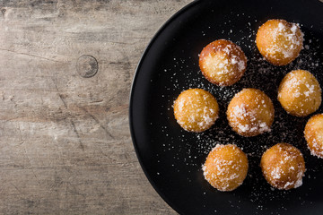 Carnival fritters or buñuelos de viento for holy week on wooden table. Top view copy space	