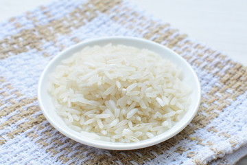 Natural raw white rice grains, on display in bowl