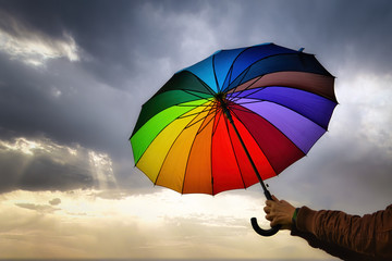 Colourful umbrella under a cloudy sky