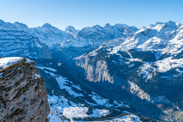 Fototapeta na wymiar Parnoramic view of snow covered Swiss Alps in Grindelwald ski resort. Winter in Switzerland